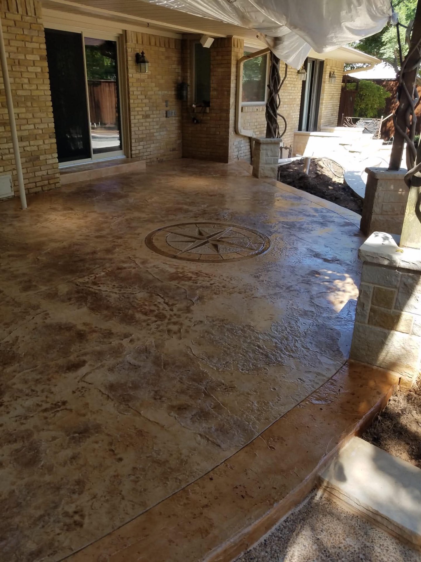 Stained Concrete w/ Compass Inlay in Keller, TX by Junior Concrete